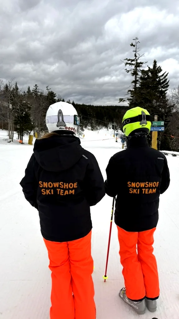 Two Snowshoe Ski Team racers looking down the slope at Snowshoe Mountain
