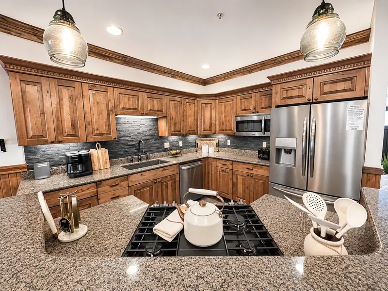Kitchen at Black Bear 32 with knotty wood cabinets, granite counters and a gas cooktop