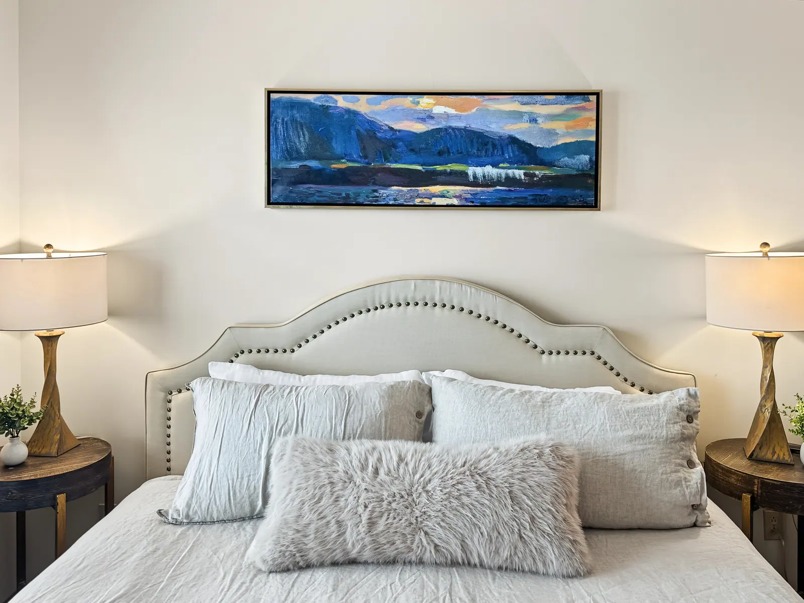 King bedroom at Black Bear 32 with a carved headboard and botanical bedding