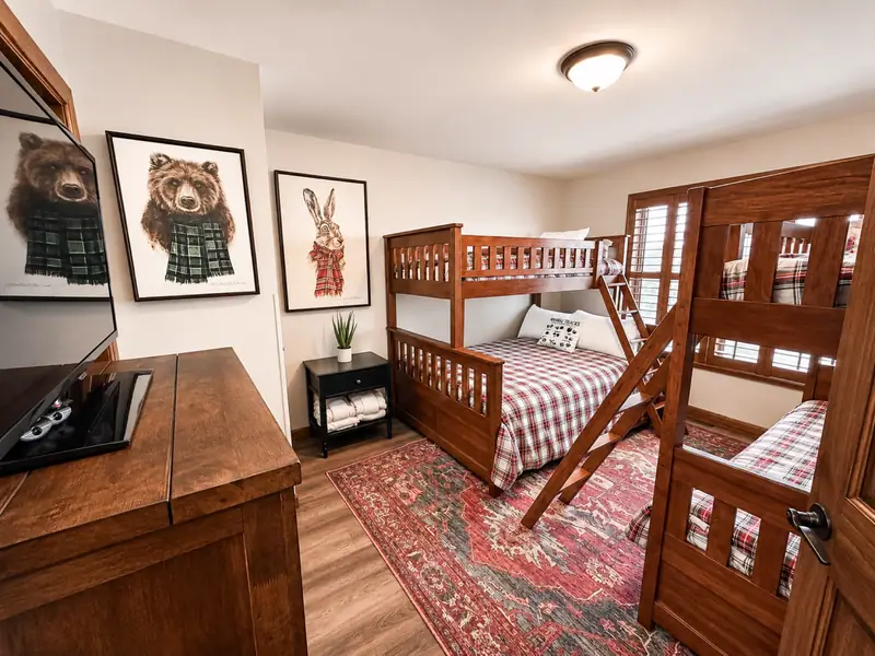 Bunk room at Black Bear 32 with a wood twin-over-full bunk and red plaid bedding