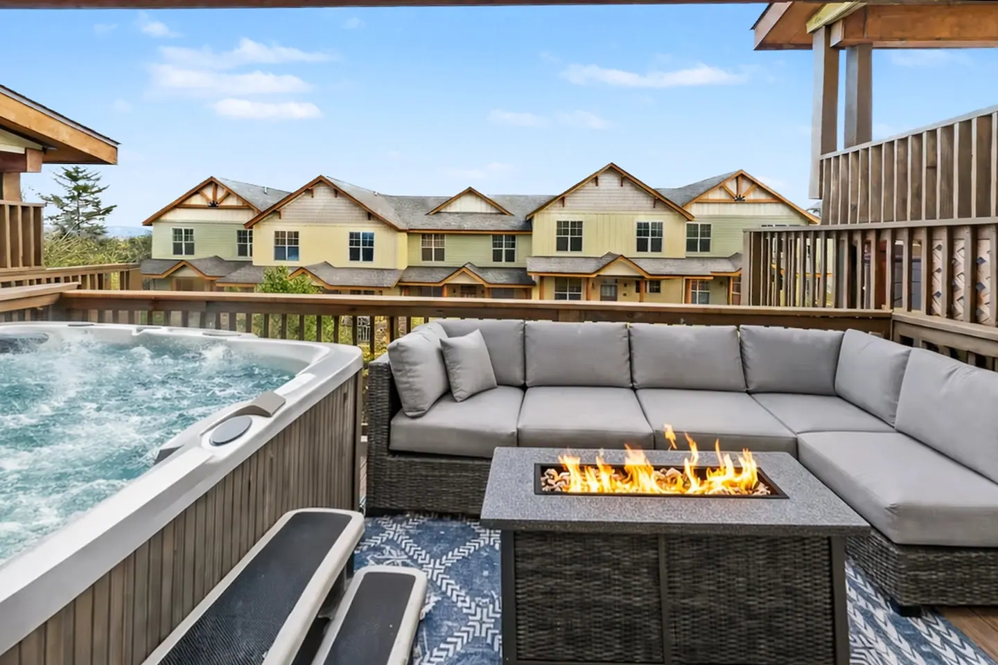 Deck at Black Bear 32 with the hot tub, fire pit table, and seating