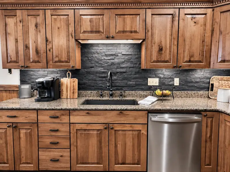 Kitchen sink wall at Black Bear 32 with slate backsplash and stainless dishwasher