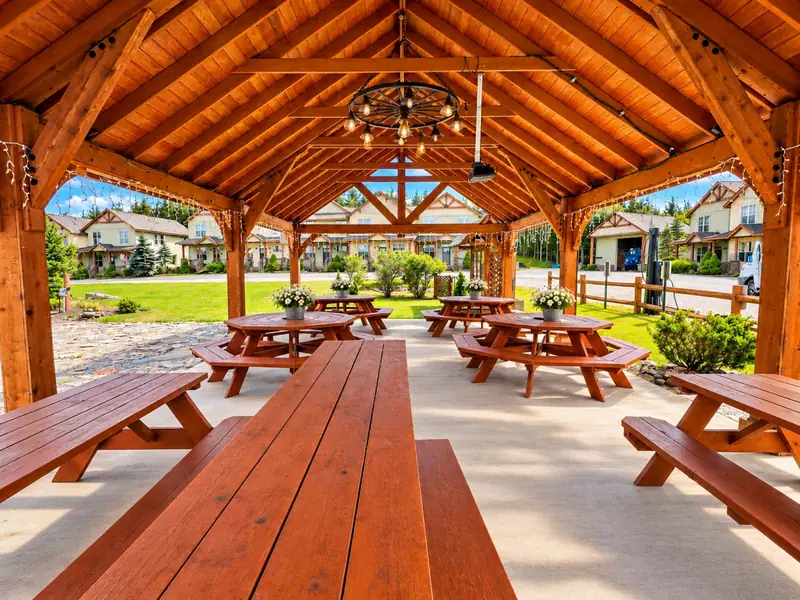 Picnic tables under the timber roof of the Black Bear Crossing pavilion
