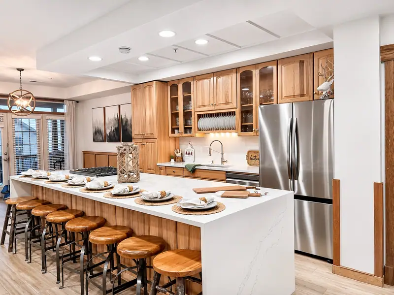 Kitchen at Black Bear 33 with a long white waterfall island and bar stools