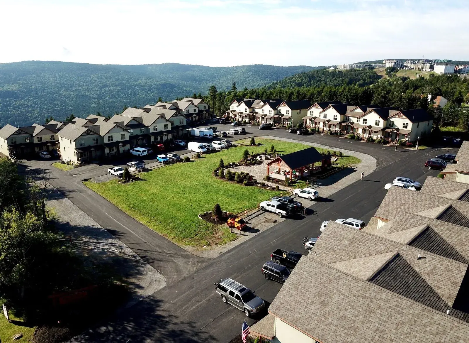 Summer aerial view of Black Bear Crossing with the pavilion lawn and the townhomes along the ridge
