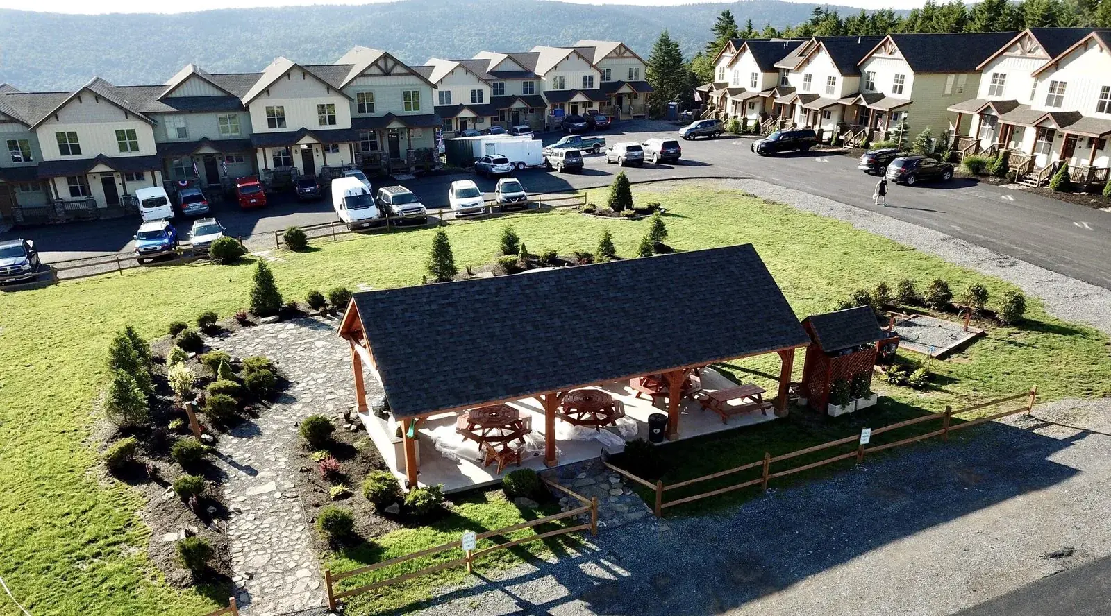 The Black Bear Crossing pavilion and lawn from above, with townhomes behind