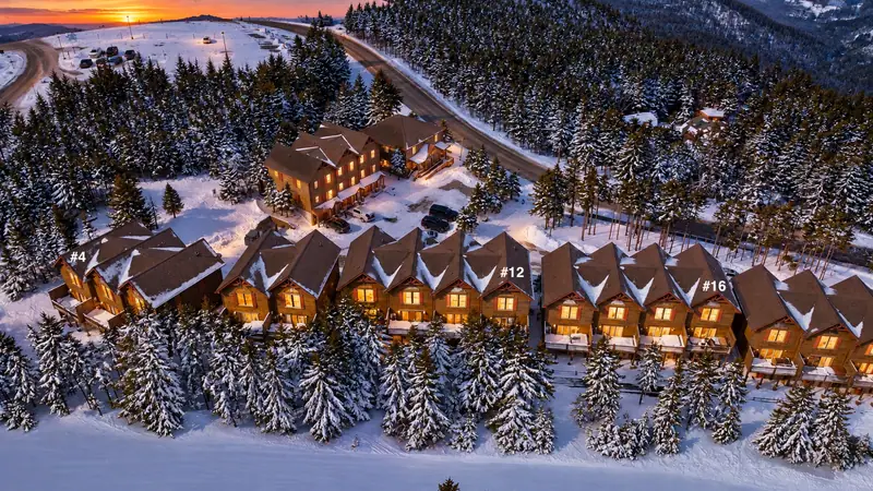 Illustrated aerial of the Loggers Run townhomes in the snow at dusk