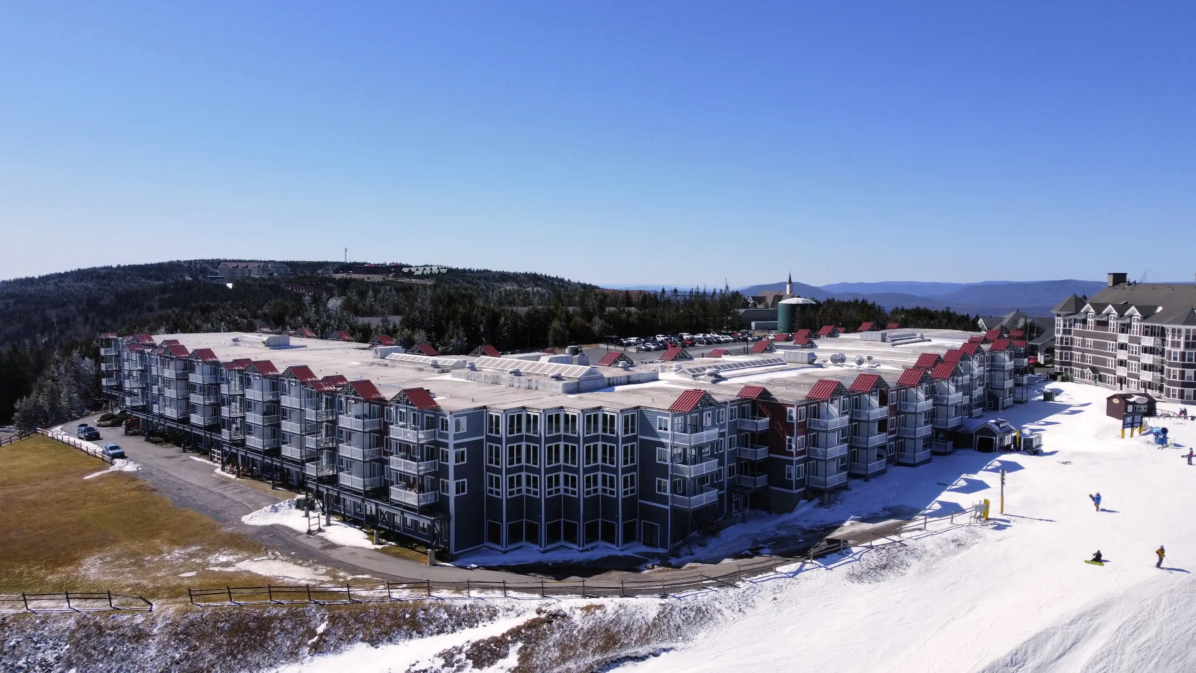 Aerial view of the Mountain Lodge building beside the slopes in March