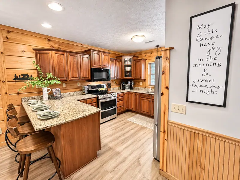 Kitchen at Loggers Run 12 with cherry cabinets, granite counters and stainless appliances
