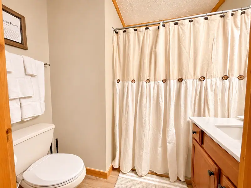 Shared top-floor bathroom at Loggers Run 12 with a shower/tub combo