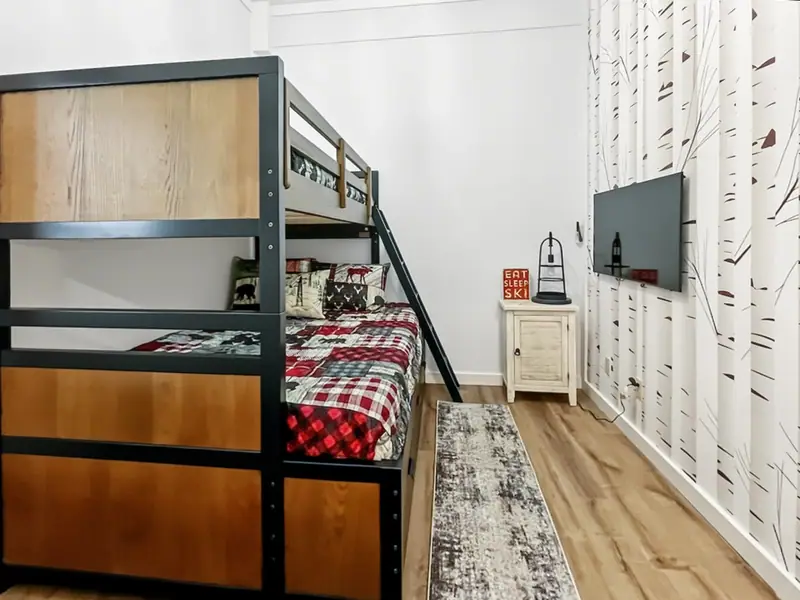 Bedroom at Loggers Run 12 with a bunk bed and floor-to-ceiling birch tree wallpaper