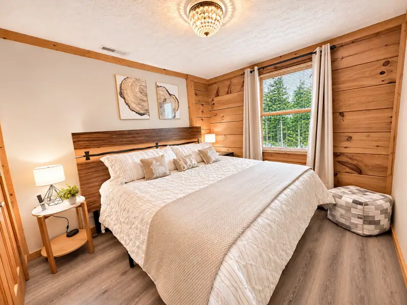 King bedroom at Loggers Run 12 with white bedding and tree-ring art