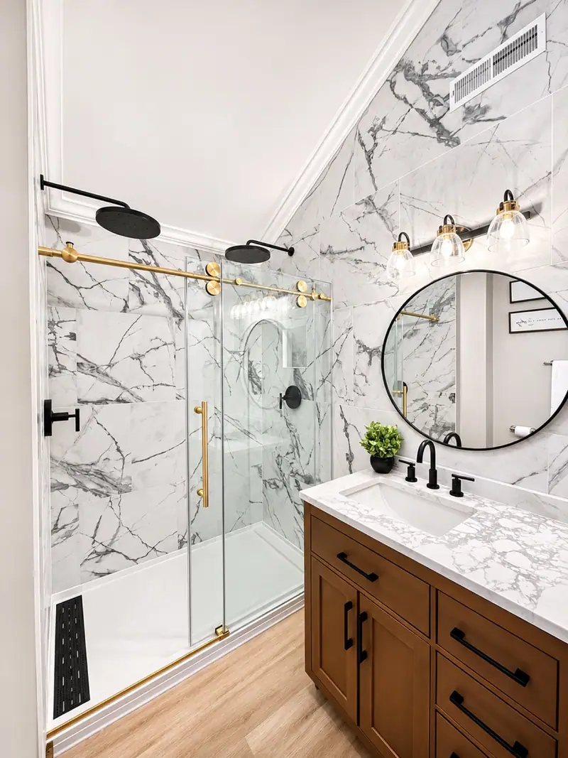 Renovated primary bathroom at Loggers Run 12 with a marble walk-in shower and a round mirror