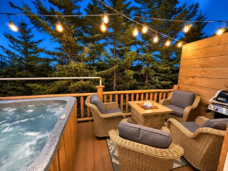 The Loggers Run 12 deck at dusk with string lights, the hot tub and a fire table
