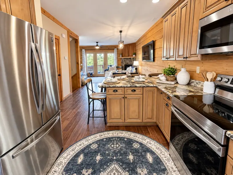 Kitchen at Loggers Run 16 with a stainless fridge, maple cabinets and granite counters