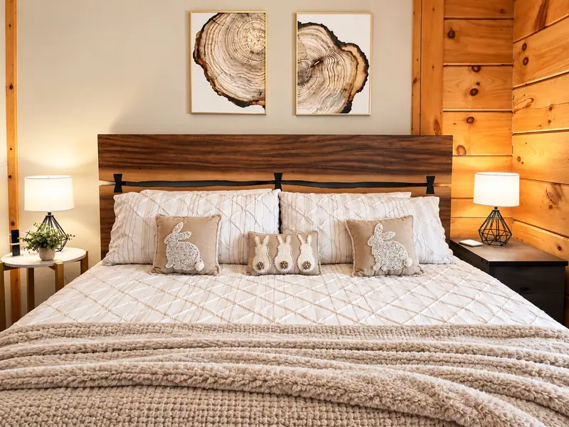 King bed at Loggers Run 16 with a wood headboard and tree-ring prints