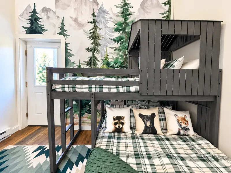 Bunk room at Loggers Run 16 with a cabin-style bunk and a forest mural