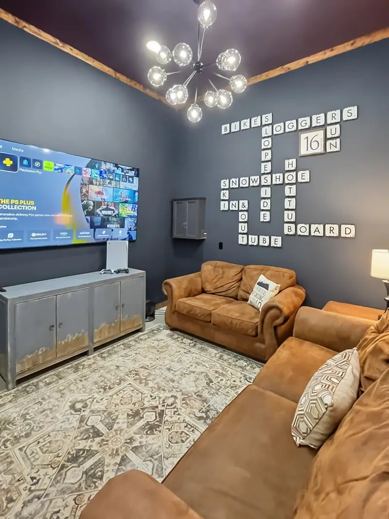Rec room at Loggers Run 16 with leather couches and a big smart TV