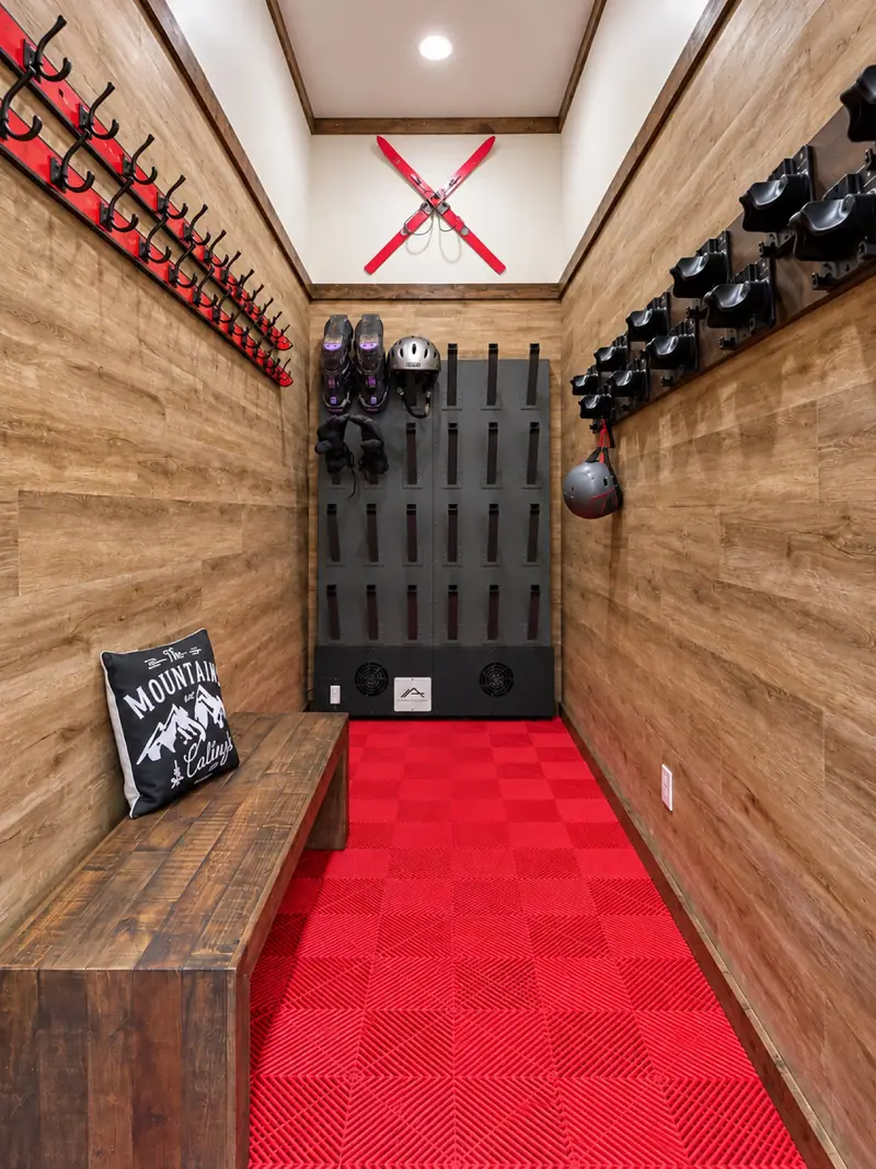 Gear room at Loggers Run 16 with boot dryers and a red runner