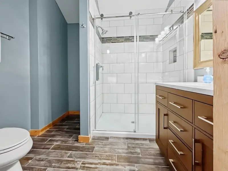 Renovated primary bathroom at Loggers Run 16 with a walk-in glass shower