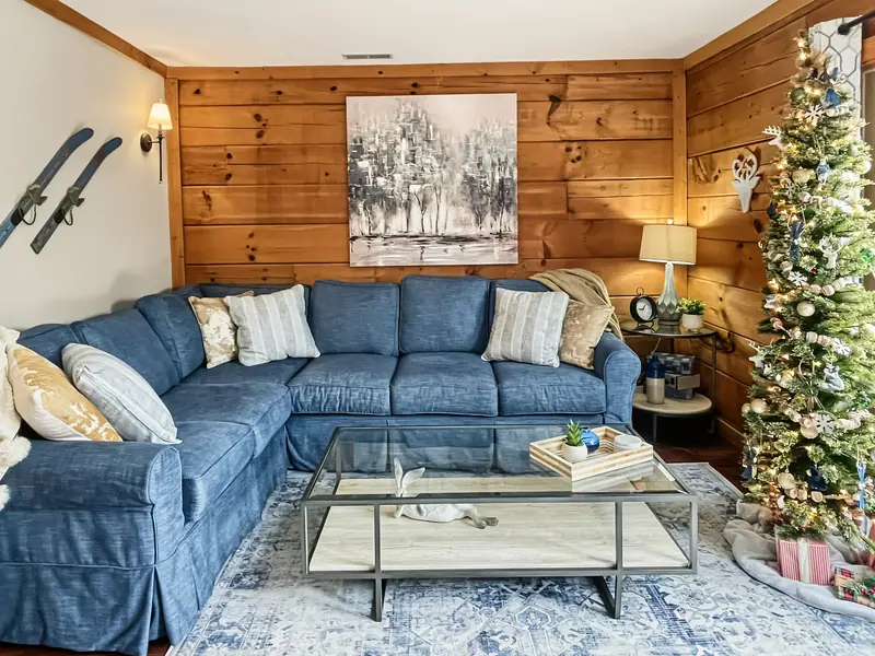 Living room at Loggers Run 16 decorated for Christmas with a tall tree