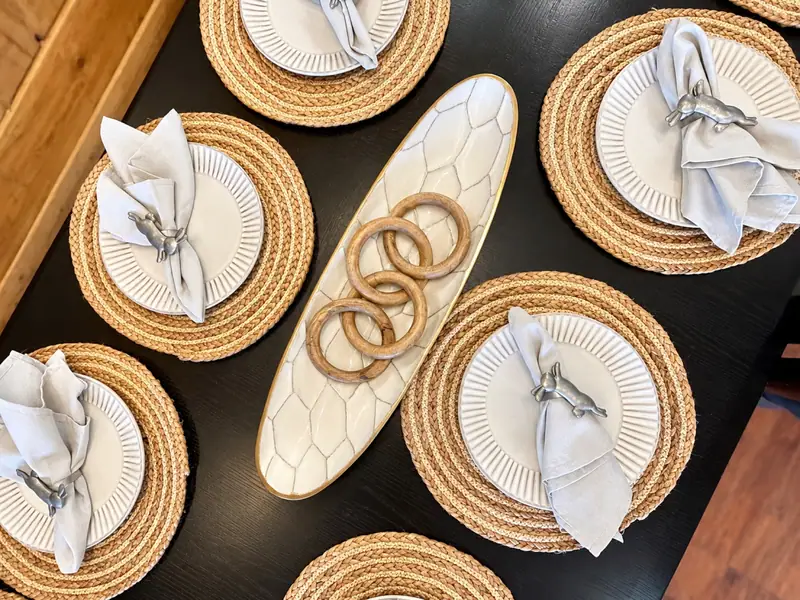 Place settings with woven chargers on the Loggers Run 16 table