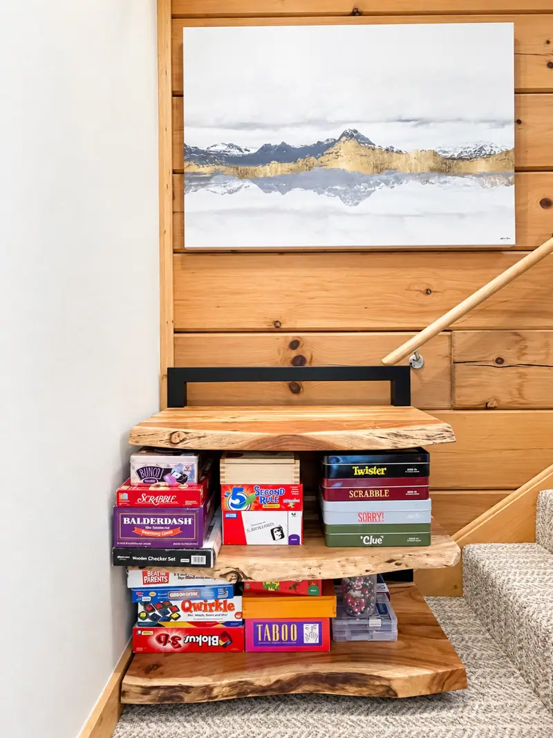 Board games stacked under mountain art at Loggers Run 16
