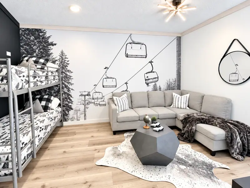 Rec room at Loggers Run 4 with a sectional, a chairlift mural and twin bunks along the wall