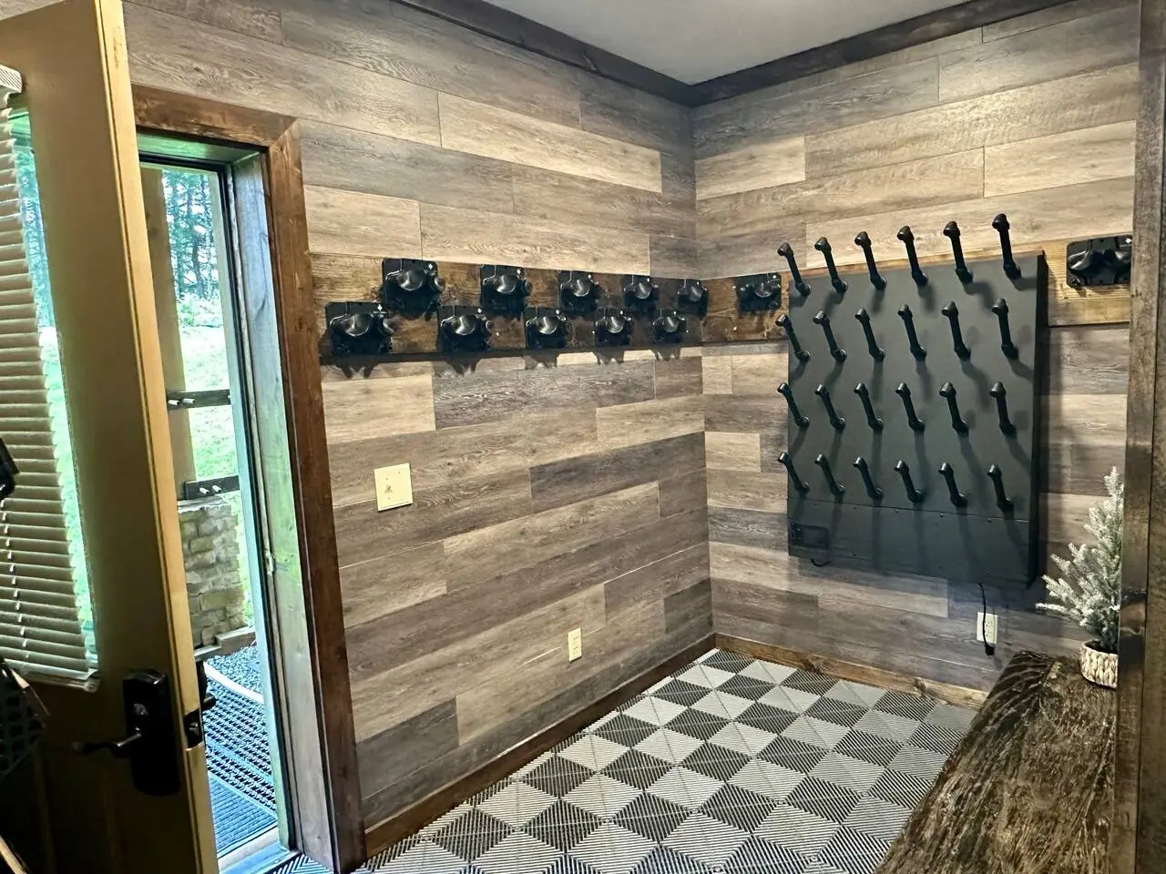Gear room with boot and glove dryers and a door straight out to the snow