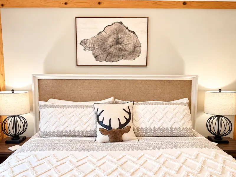 King bed at Loggers Run 4 with an upholstered headboard and antler pillow