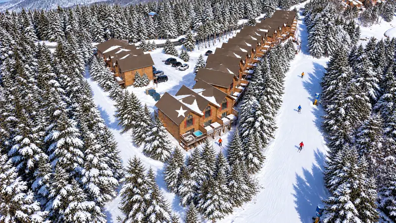 Illustrated winter aerial of the Loggers Run townhomes beside the ski trail, with Loggers Run 4 marked by a star