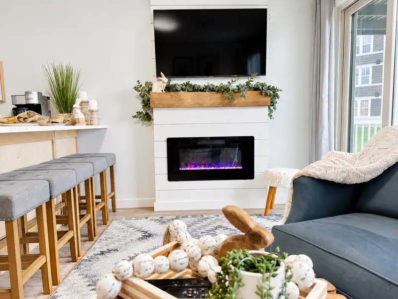 Living room at Mountain Lodge 114 with an electric fireplace, wall TV and bar seating