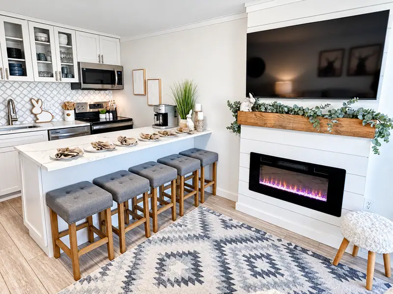 Breakfast bar at Mountain Lodge 114 with four stools facing the electric fireplace