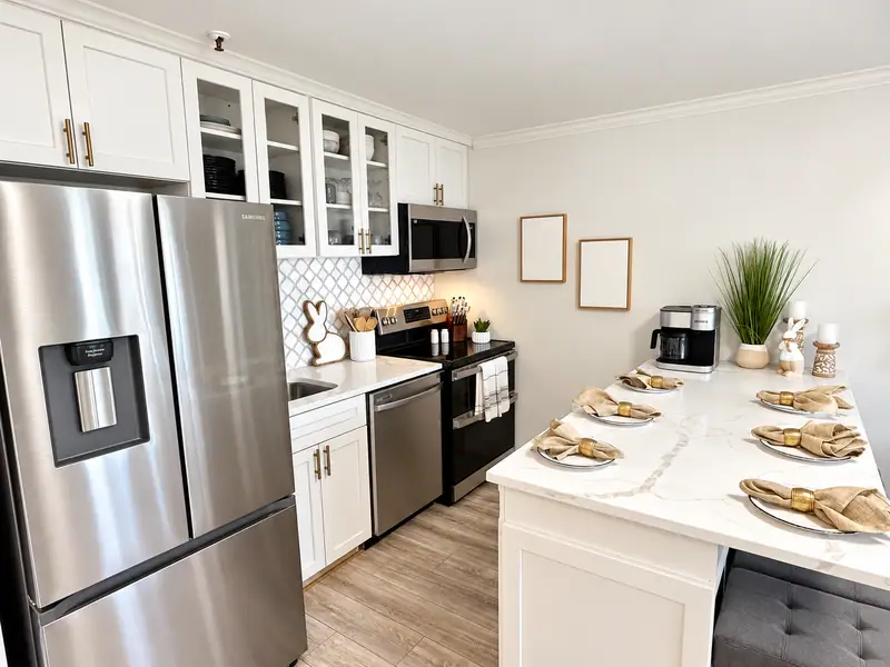 Kitchen at Mountain Lodge 114 with a stainless fridge and set breakfast bar
