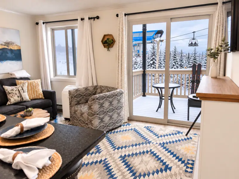 Living area at Mountain Lodge 140 with a sliding door to the balcony and lift view