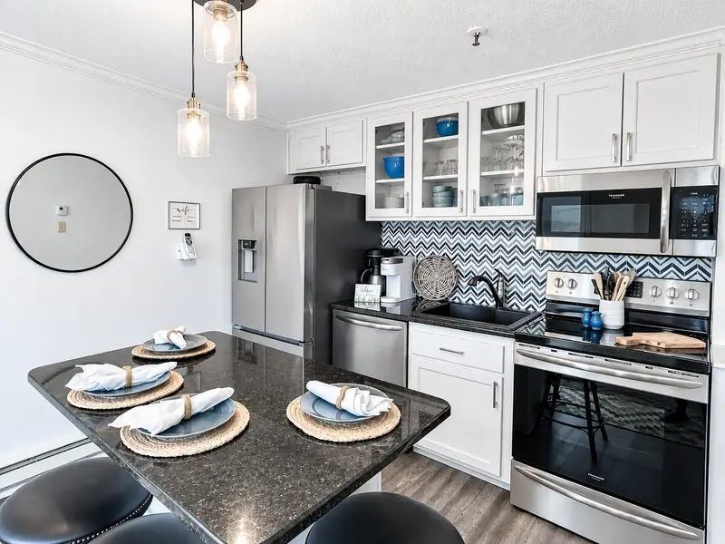 Kitchen island at Mountain Lodge 140 with pendant lights and place settings