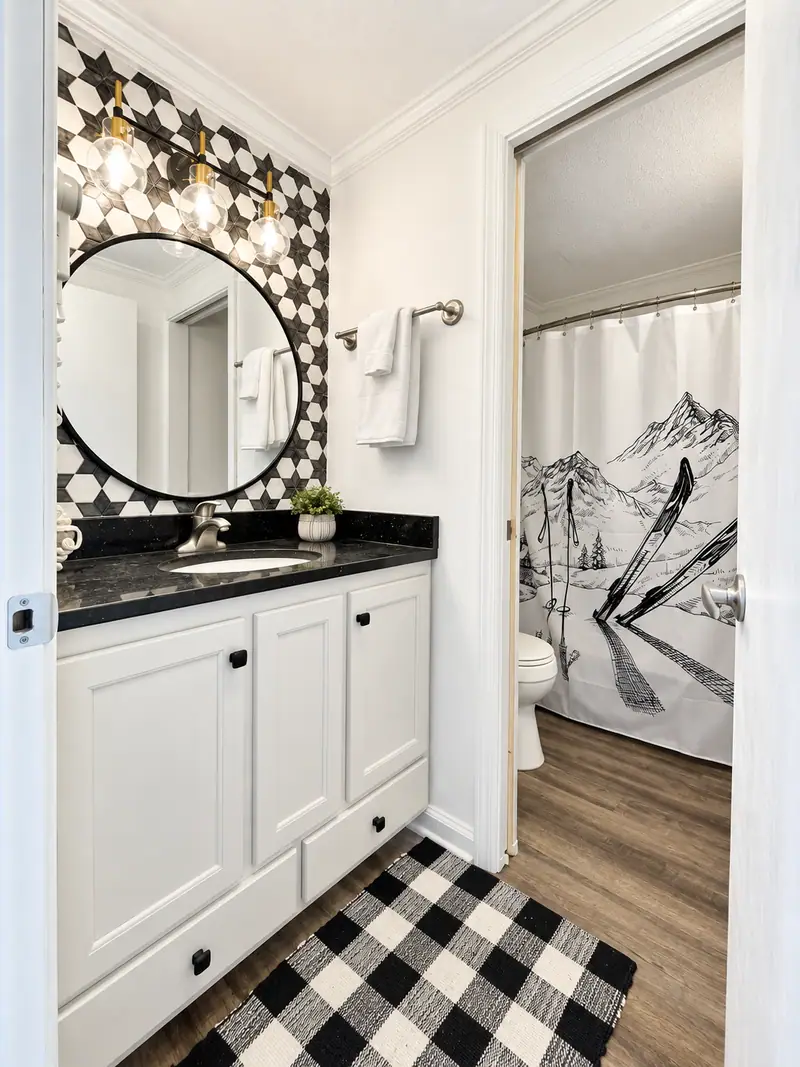 Bathroom at Mountain Lodge 140 with a white vanity and black and white floor