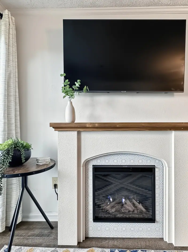 Electric fireplace with a TV above it in the living room at Mountain Lodge 140