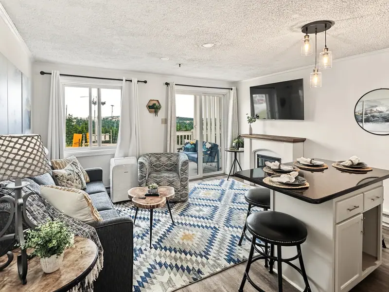 Living and kitchen area at Mountain Lodge 140 with a large smart TV