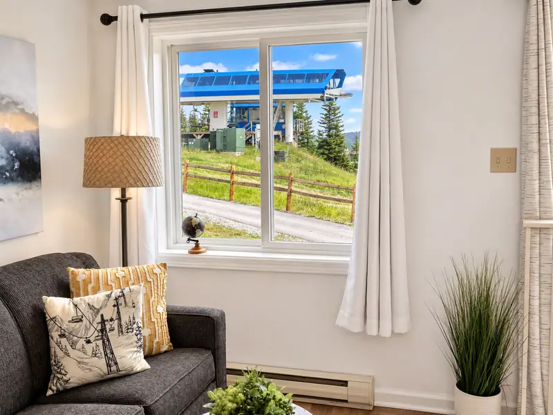 Sofa by the window at Mountain Lodge 140 with a view of the Ballhooter lift