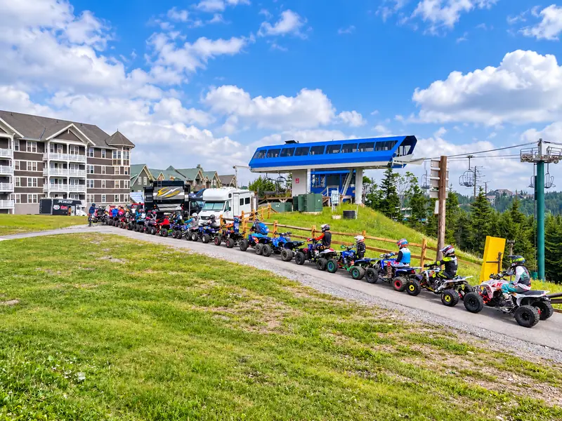 ATVs lined up below the Ballhooter lift near Mountain Lodge in summer