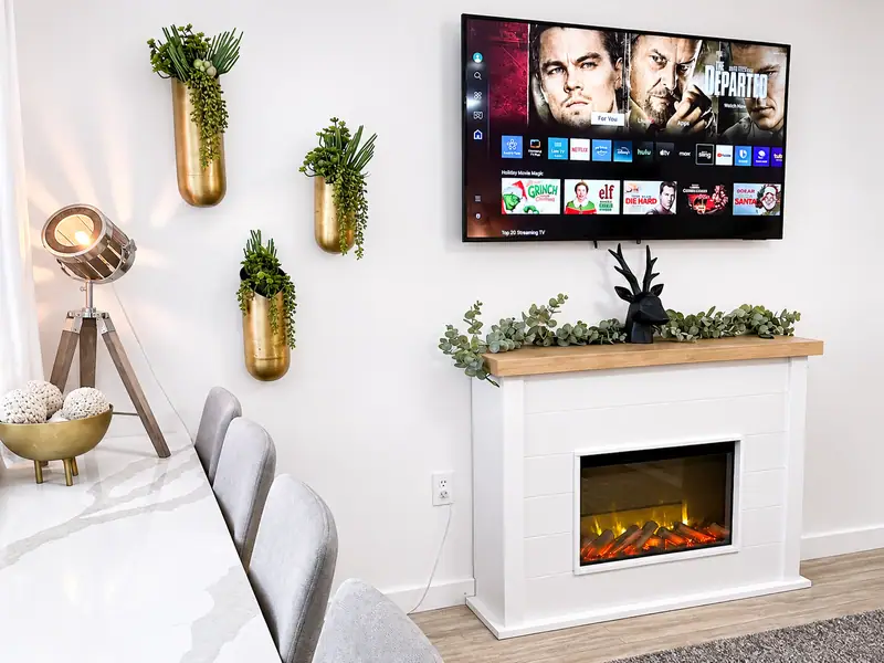 Electric fireplace, wall TV and gold wall planters at Mountain Lodge 144