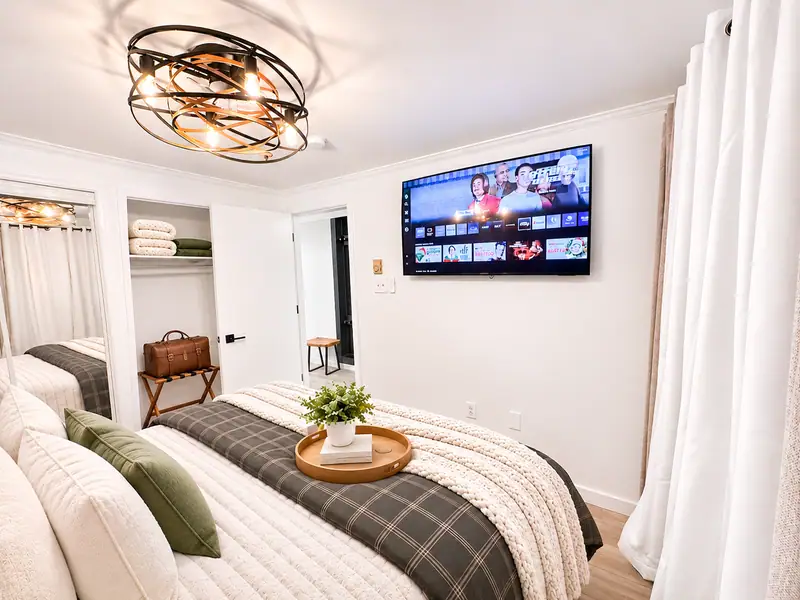 Bedroom at Mountain Lodge 144 with a wall TV and plaid throw