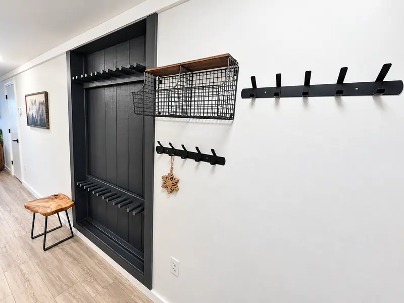 Entry storage at Mountain Lodge 144 with wall hooks and a black cabinet