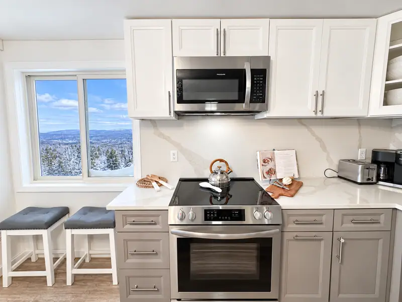 Kitchen at Mountain Lodge 146 with a stainless range and window over the counter