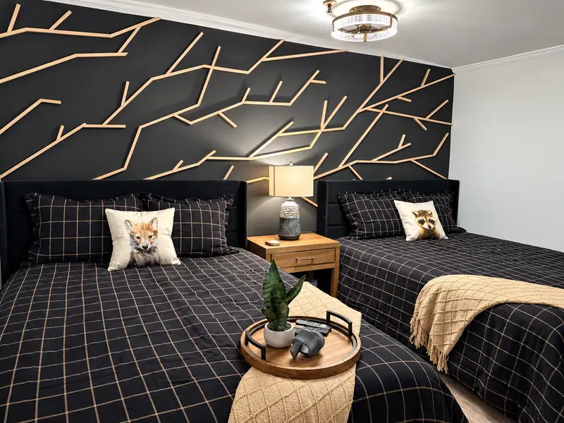Bedroom at Mountain Lodge 146 with two queen beds and a gold line mural