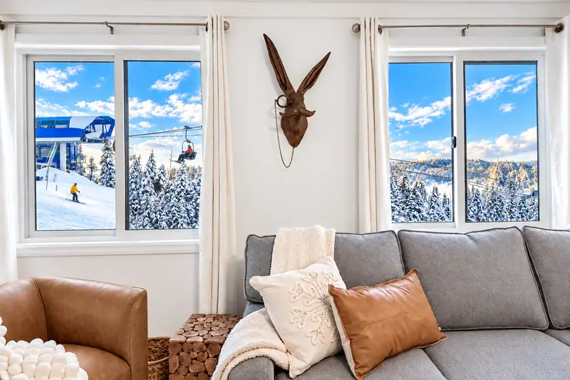 Sofa under two windows at Mountain Lodge 146 with a view of the Ballhooter lift