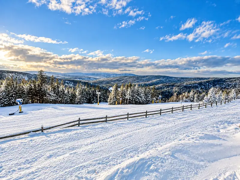 Snowy slope and distant mountains outside Mountain Lodge 146