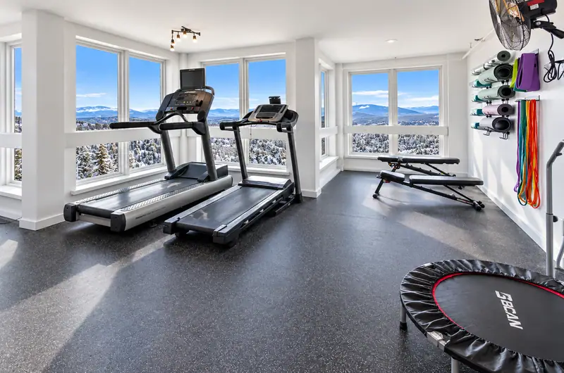 Fitness room at Mountain Lodge with treadmills and mountain-view windows