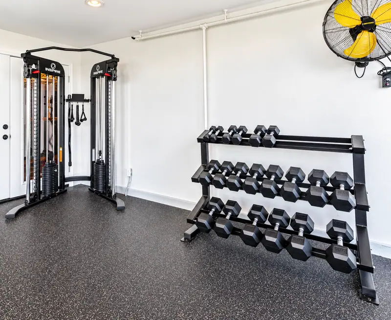 Dumbbell rack and cable machine in the Mountain Lodge fitness room